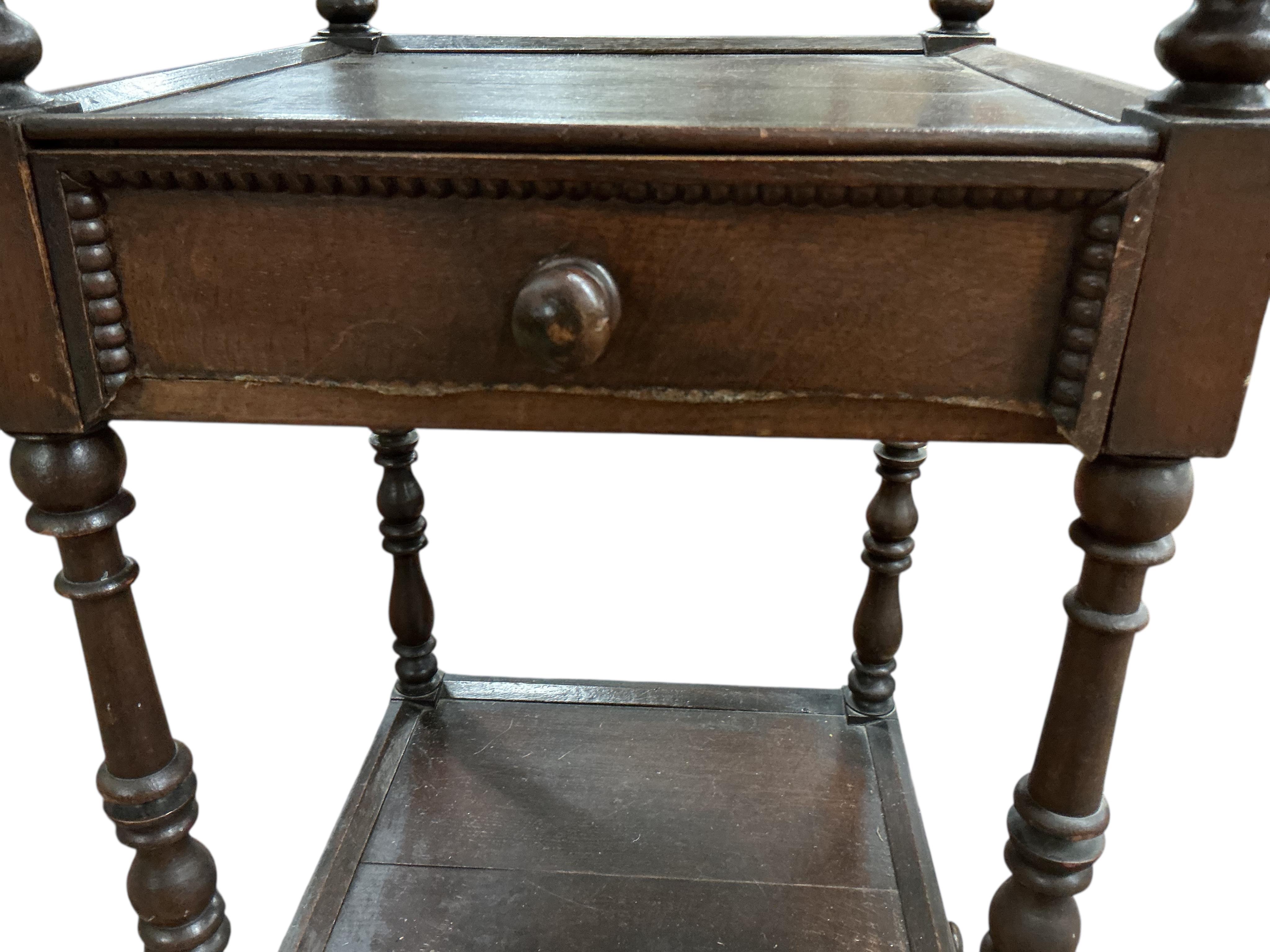 A Regency style oak three tier whatnot, width 46cm, height 136cm
